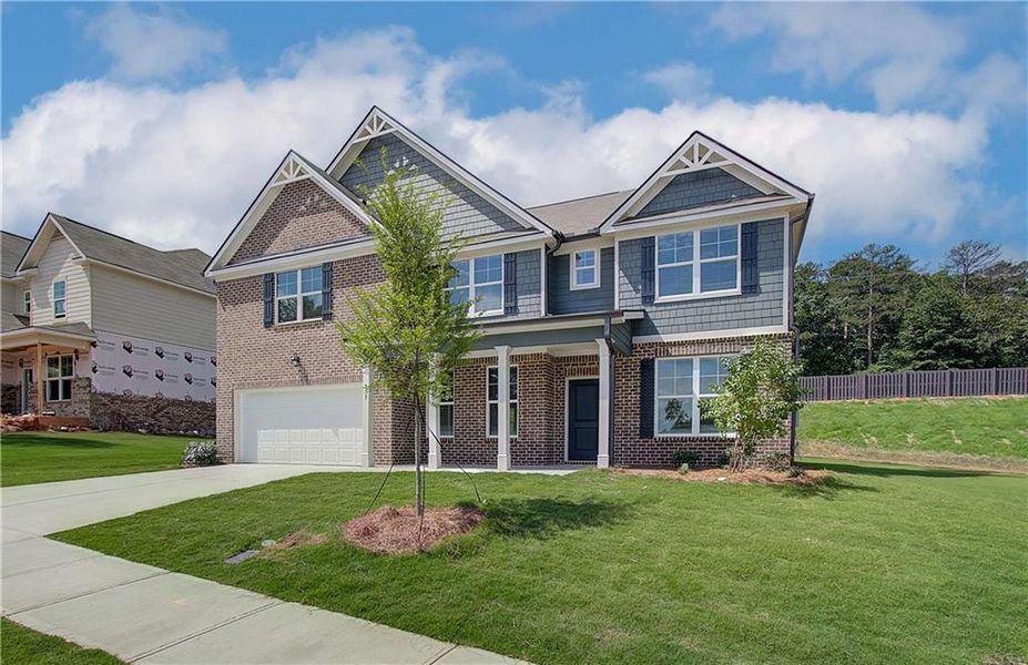 Front exterior of a new home in Kingsmere Estates, Loganville, GA, highlighting curb appeal (Image 24).