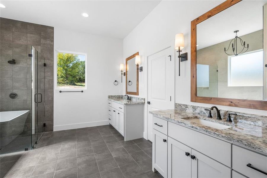 Scenic and functional with separate vanities, recessed lighting, custom cabinets and beautiful flooring.