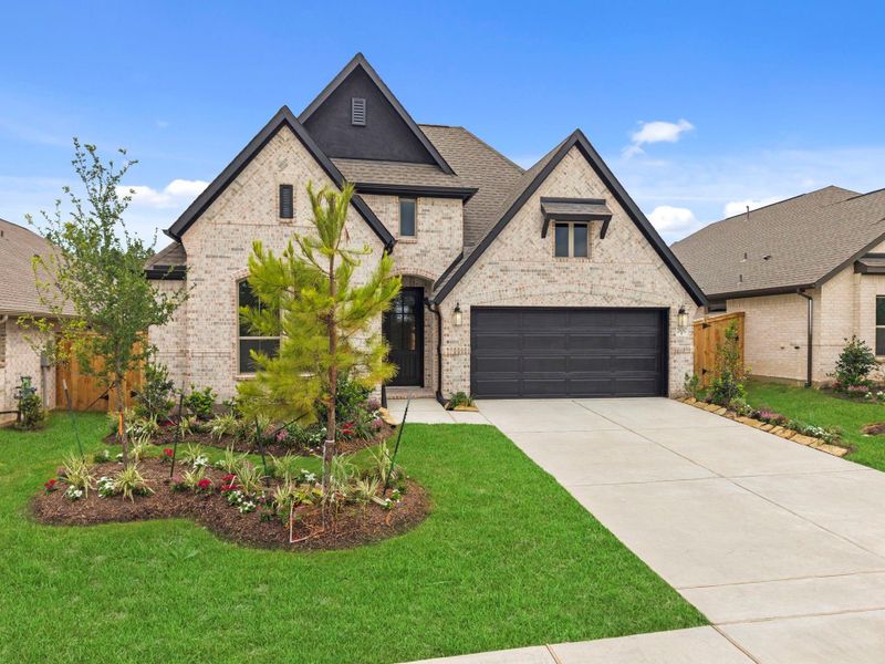 Front exterior of a new home in Wildtree, Magnolia, TX, highlighting curb appeal (Image 20).