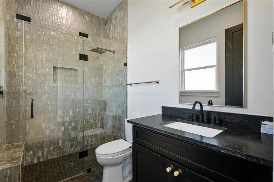 Bathroom featuring a shower stall, vanity, and tile patterned floors