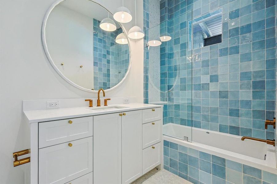 Bedroom 2 boasts a spa-like ensuite bath featuring quartz counters and beautiful satin finish bronze fixtures.