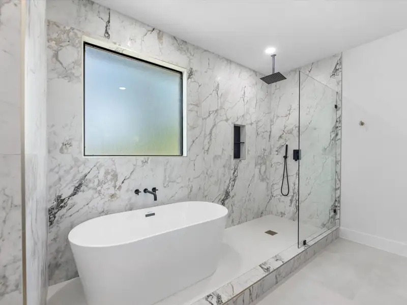 Enjoy this large soaking tub and rainfall shower!