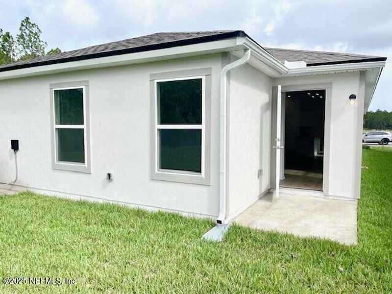 Exterior details and patio area of a home in Grand Reserve, Bunnell (Image 3).