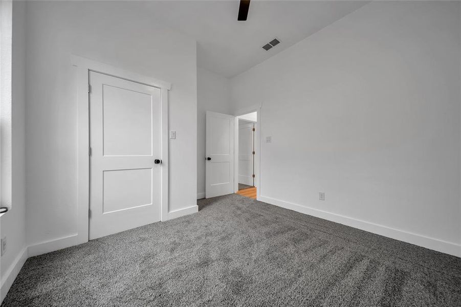 Unfurnished bedroom with carpet floors and ceiling fan