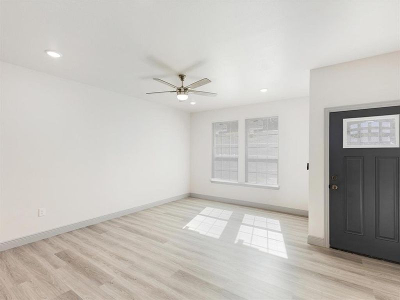 Entryway featuring light wood-style flooring, ceiling fan, and recessed lighting