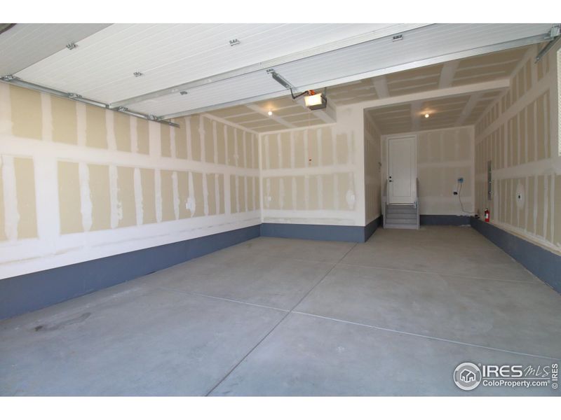 Oversized 3 car tandem garage, smart opener, 8' garage door, fully drywalled.