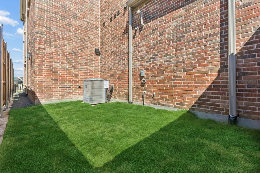 Exterior details and patio area of a home in Newman Village Townhomes, Frisco (Image 3).