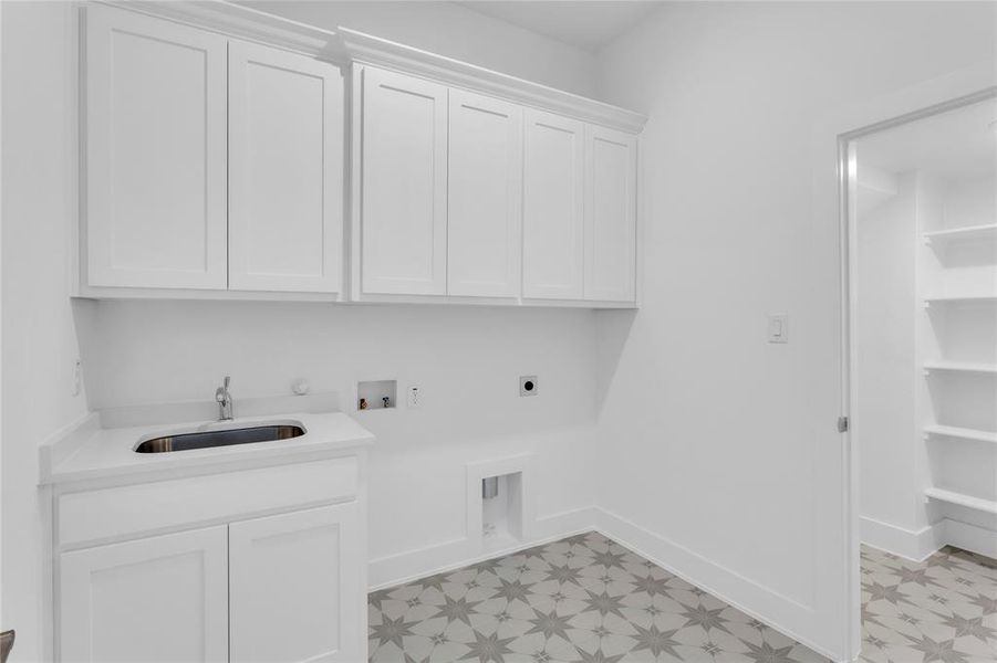 Laundry room featuring light flooring, washer hookup, electric dryer hookup, and cabinet space