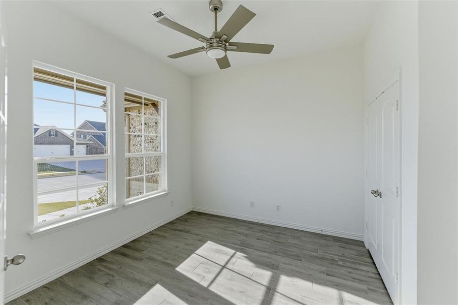 Unfurnished room with light wood-style floors and a ceiling fan