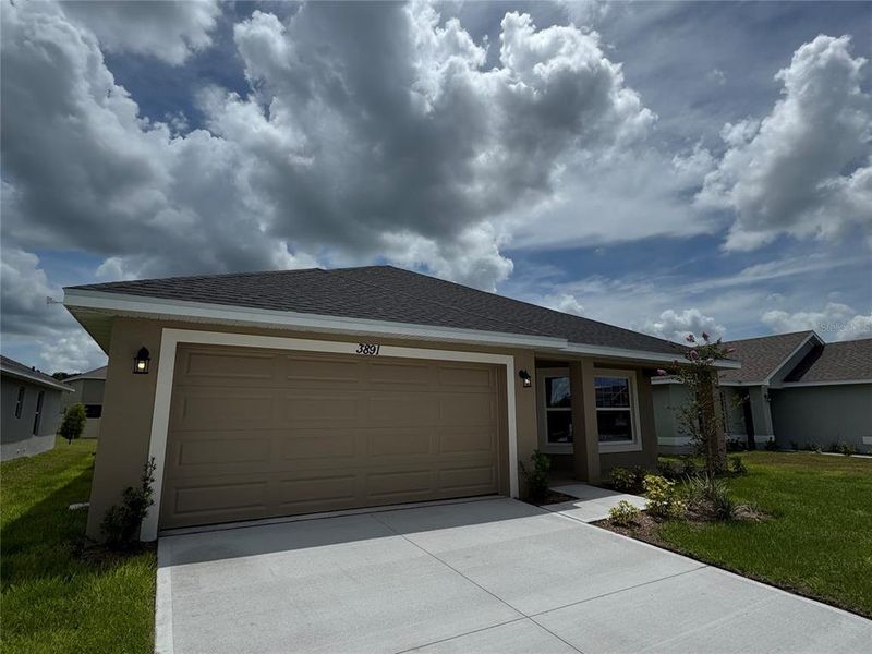 Front exterior of a new home in Harmony Central, Harmony, FL, highlighting curb appeal (Image 1).