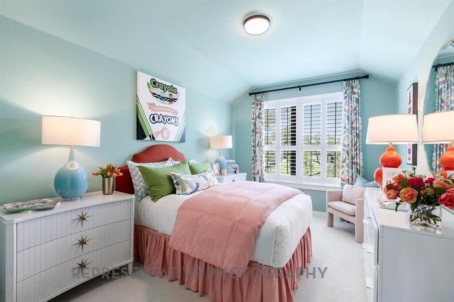 Bedroom with vaulted ceiling and carpet flooring Bedroom with vaulted ceiling and carpet flooring