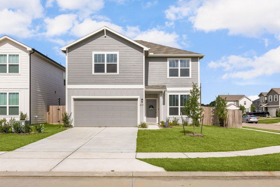 Enjoy the benefits of a spacious corner homesite with extra yard space, beautiful landscaping, and a welcoming front elevation designed for modern living.