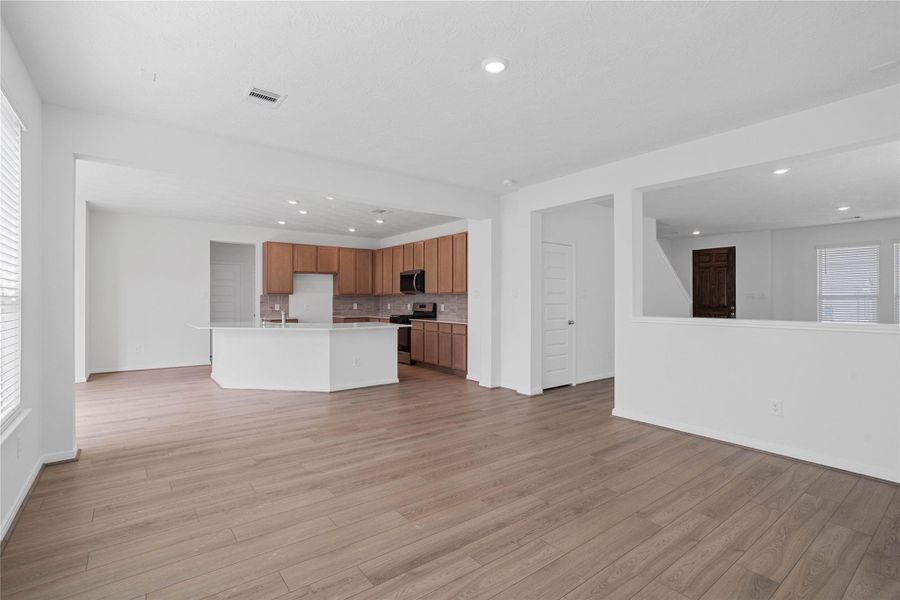 Stunning open-concept design seamlessly connecting the family, breakfast nook, and kitchen areas—perfect for both everyday living and entertaining!