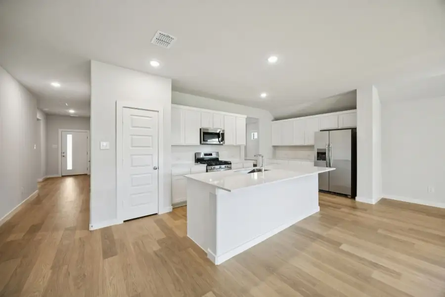 Kitchen in the Heisman home plan by Trophy Signature Homes – REPRESENTATIVE PHOTO