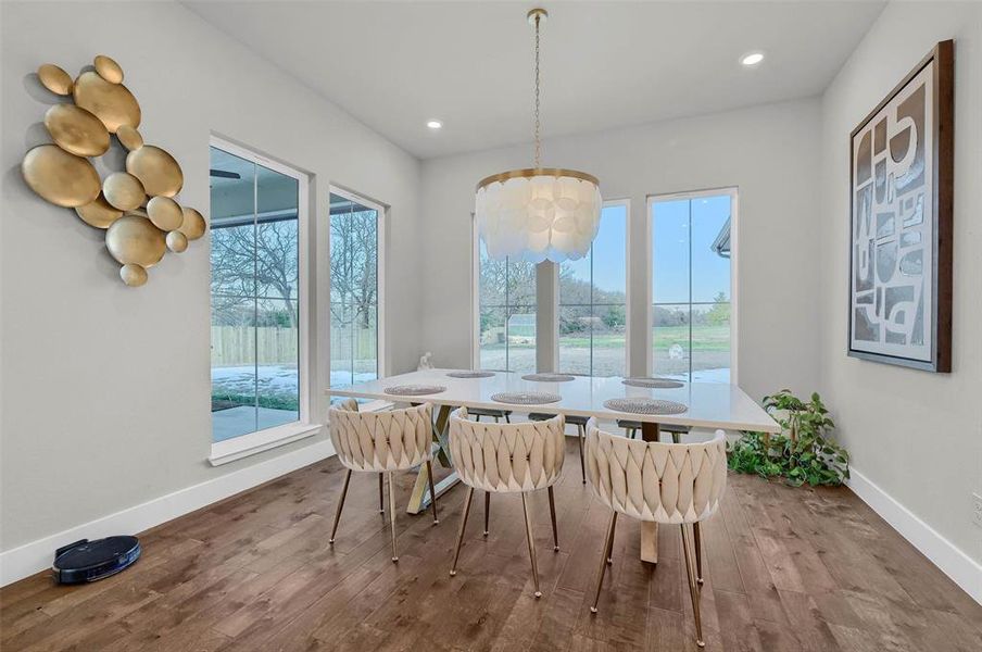 Dining space with hardwood / wood-style flooring