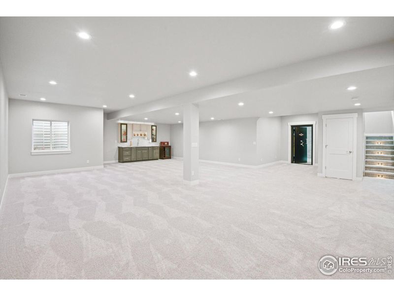 Fully finished basement with high ceilings, custom lighting and prewires