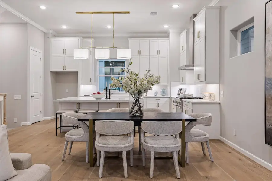 Open dining area with views of the chef-inspired kitchen and living spaces. Open dining area with views of the chef-inspired kitchen and living spaces.