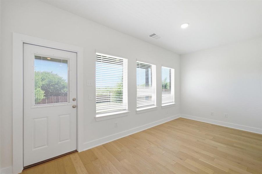 Light wood-finish flooring complements the neutral wall tones