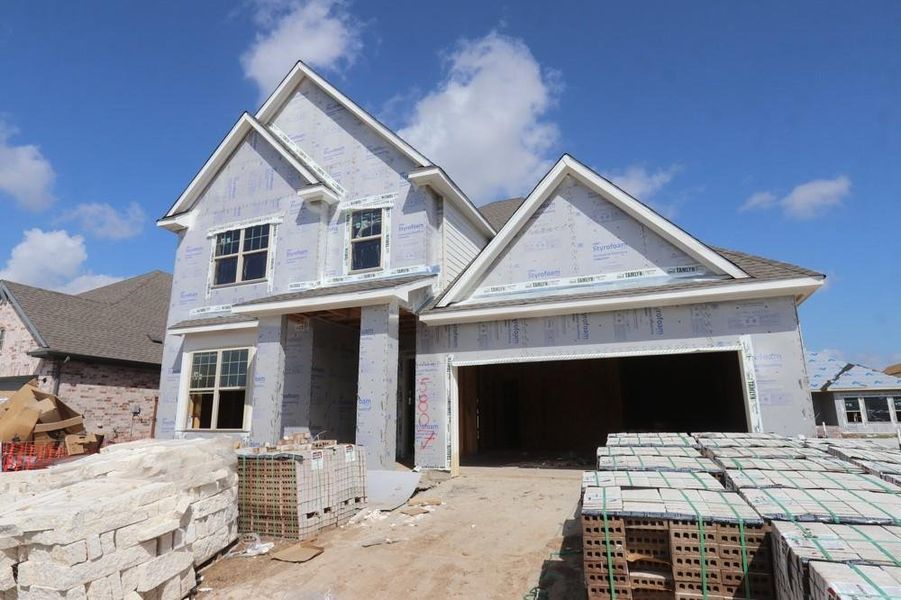 Front exterior of a new home in Meridiana 55' Homesites, Manvel, TX, highlighting curb appeal (Image 2). Front exterior of a new home in Meridiana 55' Homesites, Manvel, TX, highlighting curb appeal (Image 2).