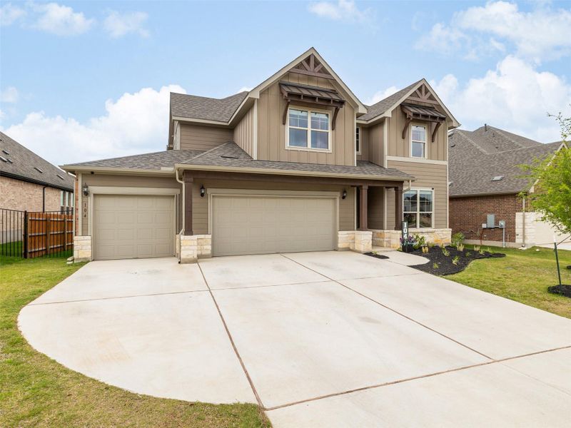Front exterior of a new home in Saddleback at Santa Rita Ranch, Liberty Hill, TX, highlighting curb appeal (Image 2). Front exterior of a new home in Saddleback at Santa Rita Ranch, Liberty Hill, TX, highlighting curb appeal (Image 2).