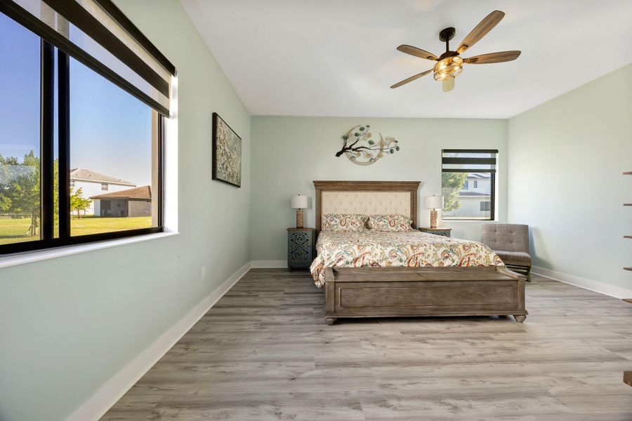 Bedroom with light wood-type flooring and a ceiling fan