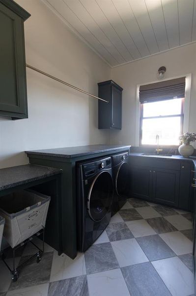 Laundry room with independent washer and dryer and cabinet space