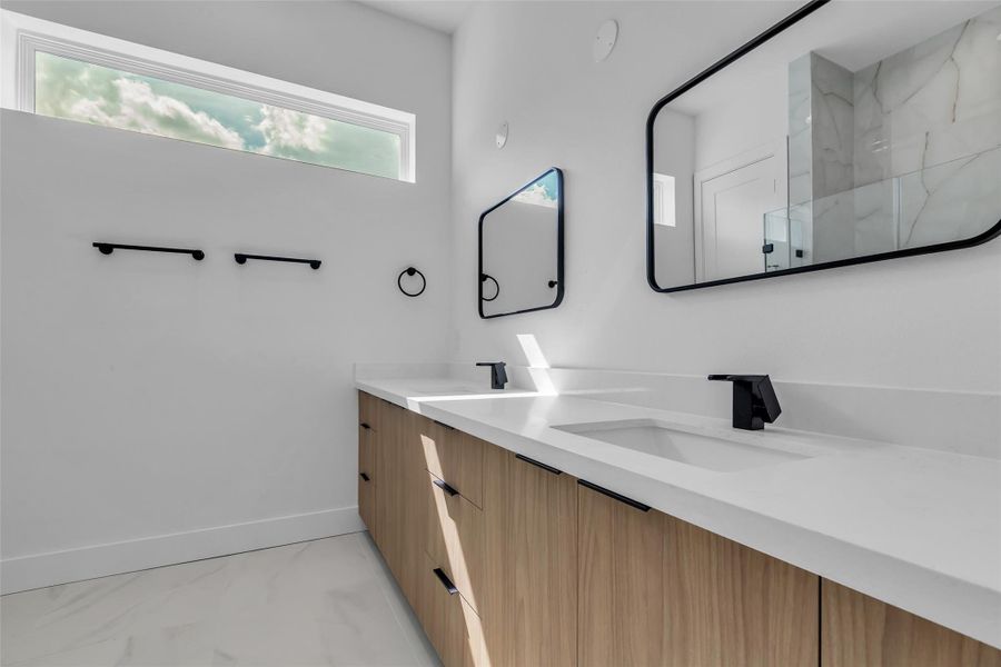 The primary bathroom features modern, sleek finishes, creating a clean and stylish space. The primary bathroom features modern, sleek finishes, creating a clean and stylish space.