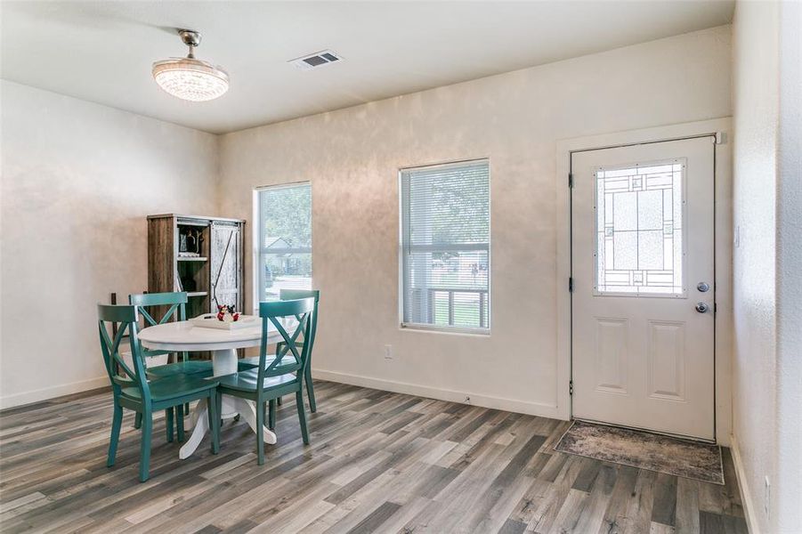 Dining space featuring healthy amount of natural light and wood finished floors Dining space featuring healthy amount of natural light and wood finished floors