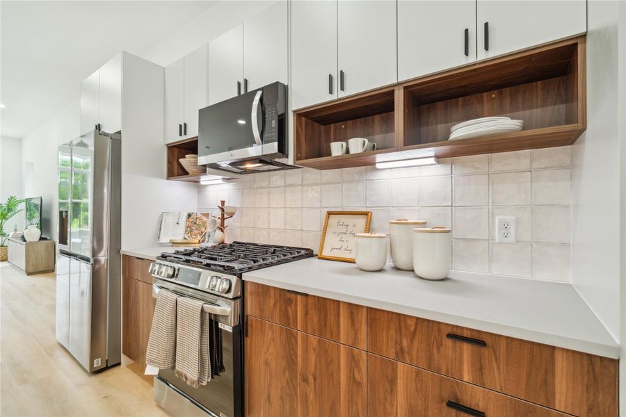 Dual-purpose cabinetry offers the best of both worlds—open shelving for display-worthy pieces and ample closed storage for everyday essentials.