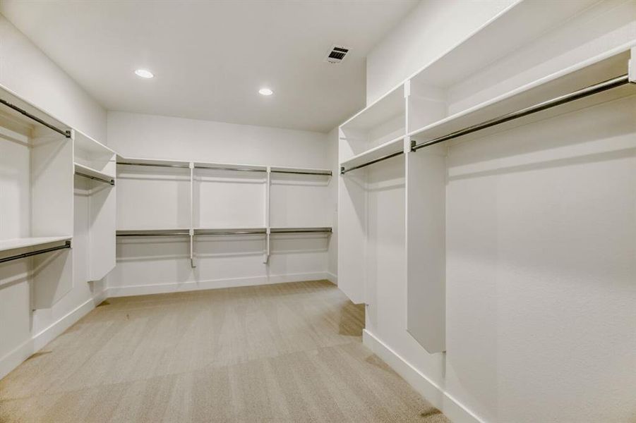 Walk in closet featuring light carpet