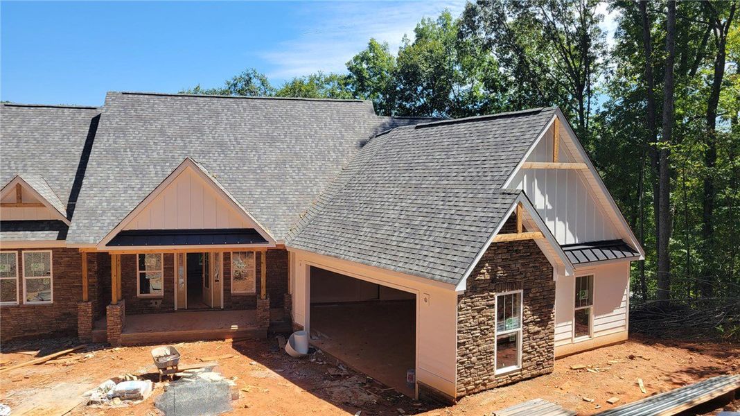 Textured stone veneer and neat board-and-batten ac Textured stone veneer and neat board-and-batten ac