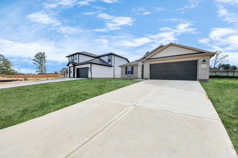 Actual exterior of construction - 90% complete. Glass front door, landscape and perimeter fence pending installation. Welcome home to 19737 Flag View Dr located in Montgomery Ridge community and zoned to highly sought after Montgomery ISD.