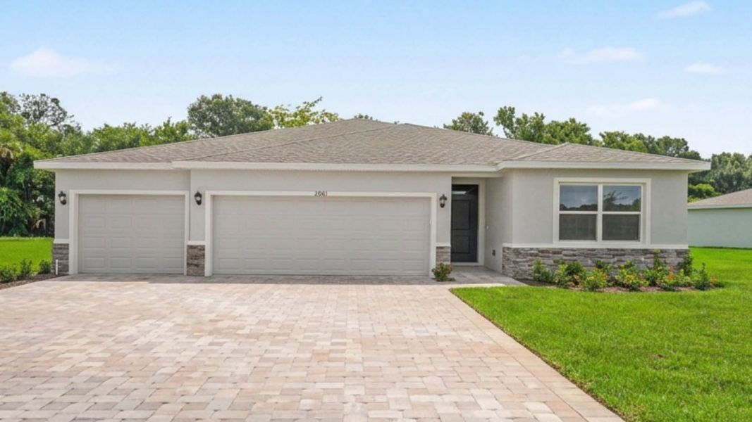 Front exterior of a new home in Indian River Preserve, Mims, FL, highlighting curb appeal (Image 1). Front exterior of a new home in Indian River Preserve, Mims, FL, highlighting curb appeal (Image 1).