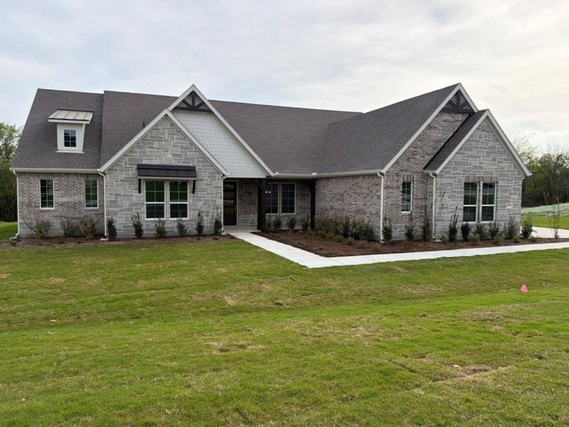 Front exterior of a new home in Grayson Ridge, Van Alstyne, TX, highlighting curb appeal (Image 16).