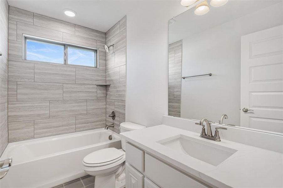 Full bathroom featuring  shower combination, vanity, and tile patterned floors