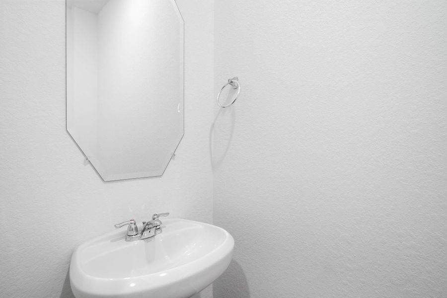 This charming home features a beautifully appointed half bath adjacent to the family room, perfect for welcoming guests and adding convenience to your daily life.