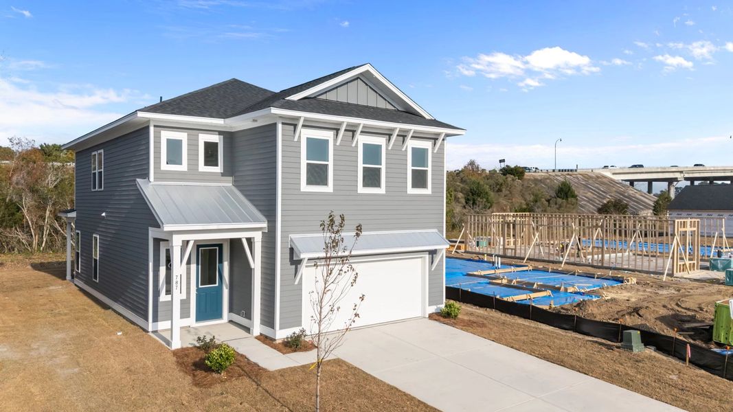 Front exterior of a new home in Blue Heron Retreat: Oasis Series, Little River, SC, highlighting curb appeal (Image 2).