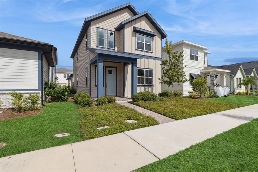 Front exterior of a new home in Weslyn Park at Sunbridge (Craft Homes), St. Cloud, FL, highlighting curb appeal (Image 1).
