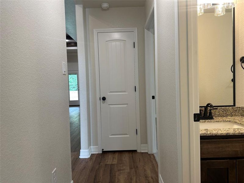 Corridor with dark wood finished floors and a textured wall Corridor with dark wood finished floors and a textured wall