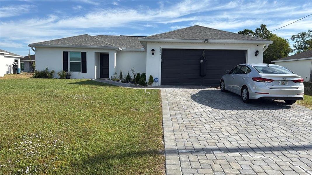 Front exterior of a new home in , Cape Coral, FL, highlighting curb appeal (Image 1). Front exterior of a new home in , Cape Coral, FL, highlighting curb appeal (Image 1).