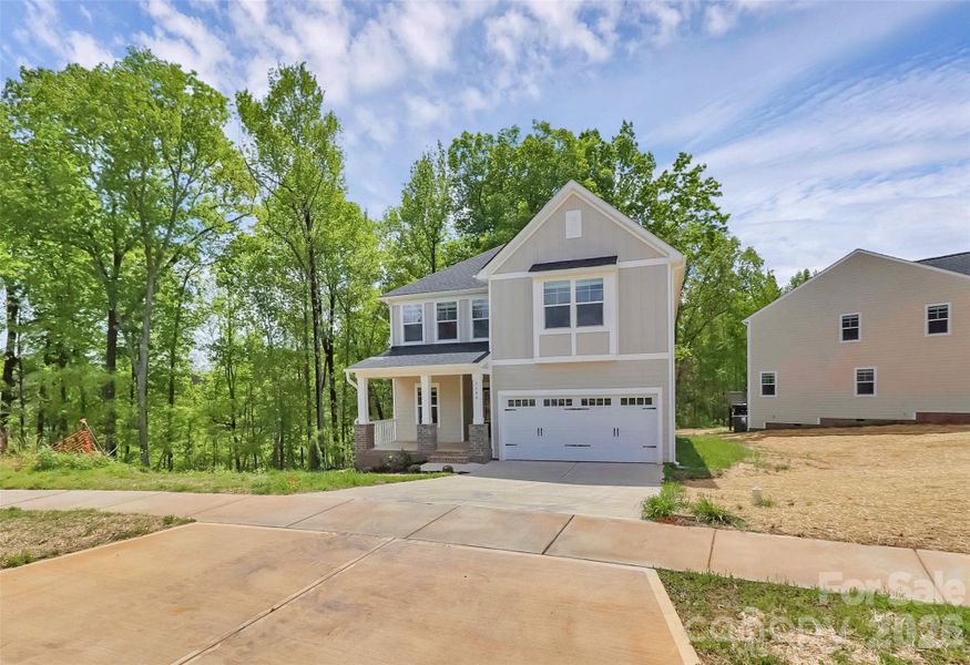 Front exterior of a new home in , Monroe, NC, highlighting curb appeal (Image 19).