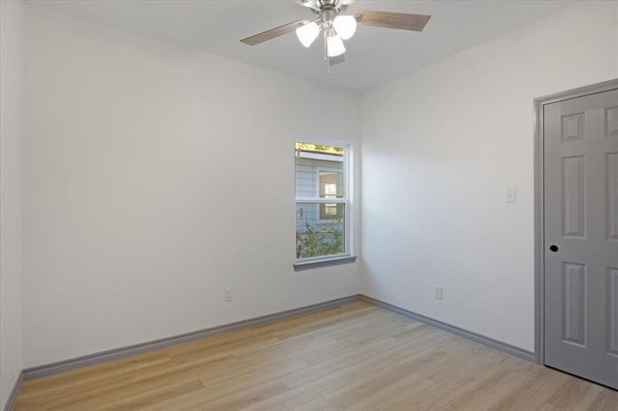 Unfurnished room with light hardwood / wood-style flooring and ceiling fan