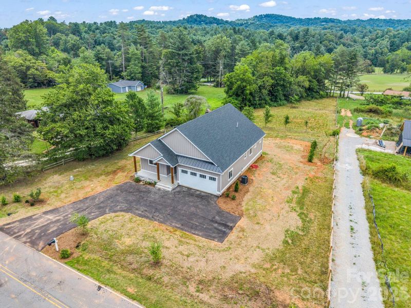 Aerial of the house and property, almost an acre of useable space, another access road behind with easement for potential garage, workshop or space for RV storage Aerial of the house and property, almost an acre of useable space, another access road behind with easement for potential garage, workshop or space for RV storage