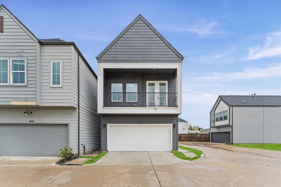 This thoughtfully designed two-story residence offers the perfect blend of modern living and practical layout. The second floor features an open-concept living, dining, and kitchen area, creating a seamless flow ideal for entertaining. Expansive windows and direct access to a private balcony from the living room invite natural light and fresh air, enhancing the indoor-outdoor experience.