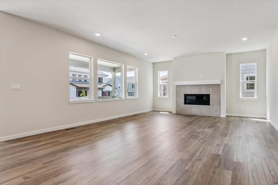 A large empty room with a fireplace.