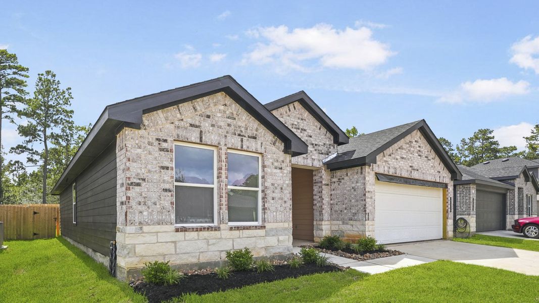 Front exterior of a new home in Grand Pines, Magnolia, TX, highlighting curb appeal (Image 16). Front exterior of a new home in Grand Pines, Magnolia, TX, highlighting curb appeal (Image 16).