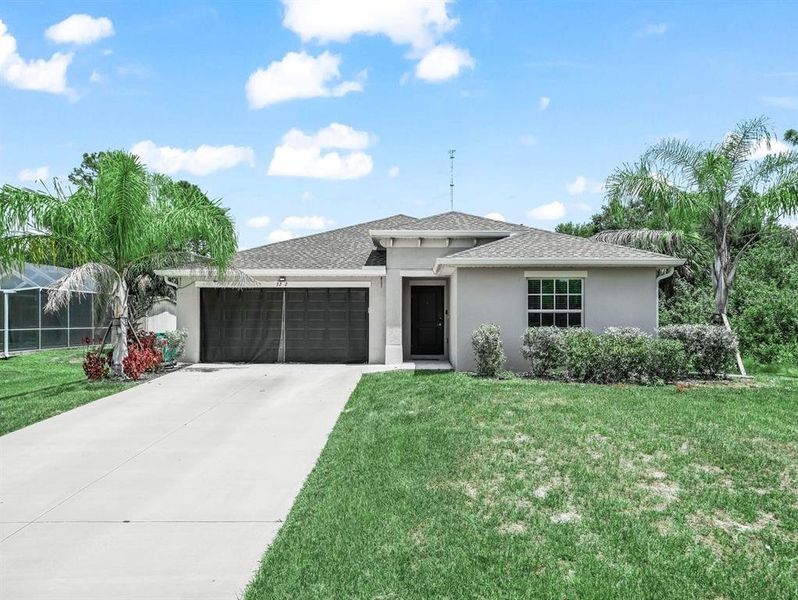 Front exterior of a new home in , Punta Gorda, FL, highlighting curb appeal (Image 1).
