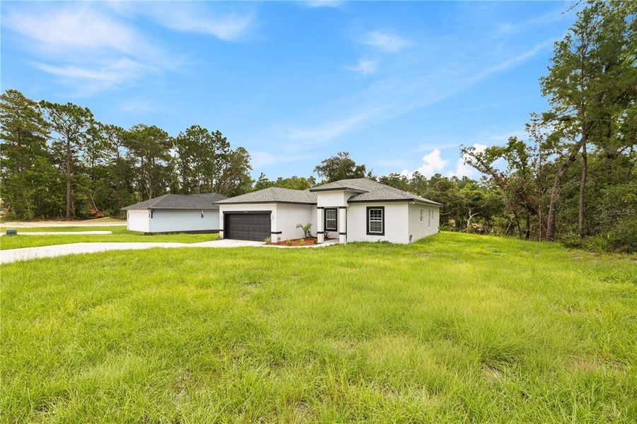 Front exterior of a new home in , Ocala, FL, highlighting curb appeal (Image 2). Front exterior of a new home in , Ocala, FL, highlighting curb appeal (Image 2).