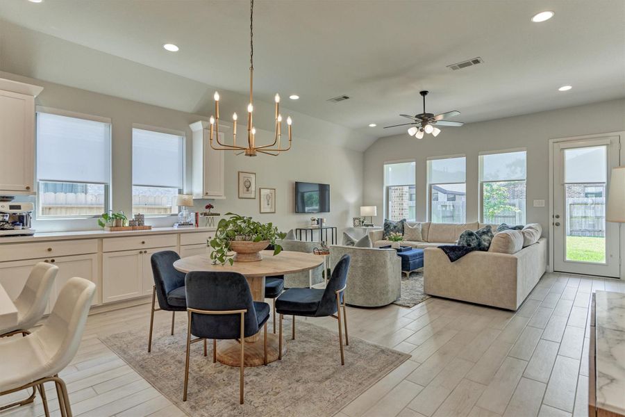 Floating dining room. The adjacent coffee/serving bar with 3 additional drawers and cupboards of storage. Six windows of natural light.  Motorized and pull shades.  Brushed gold chandlier.