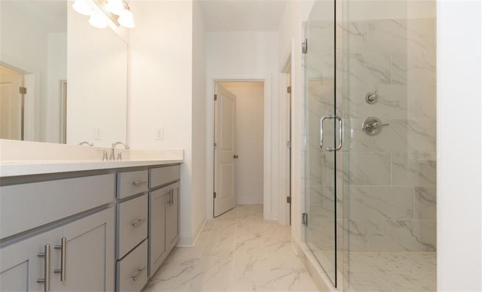 This primary bathroom will feel more like a resort.  Stunning finishes, gray cabinets and a large tub and separate shower.  Photo for representation purposes only, not of actual home but a  previously built TPG home.